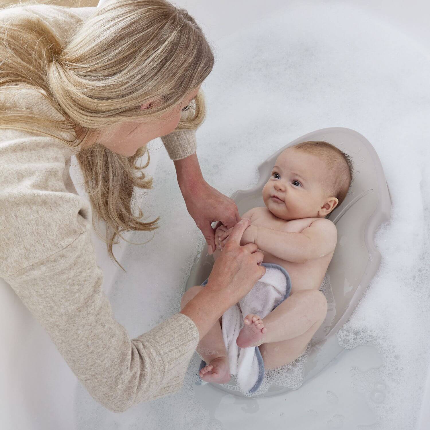 Woman washing a baby on Shnuggle Newborn Baby Bath Support