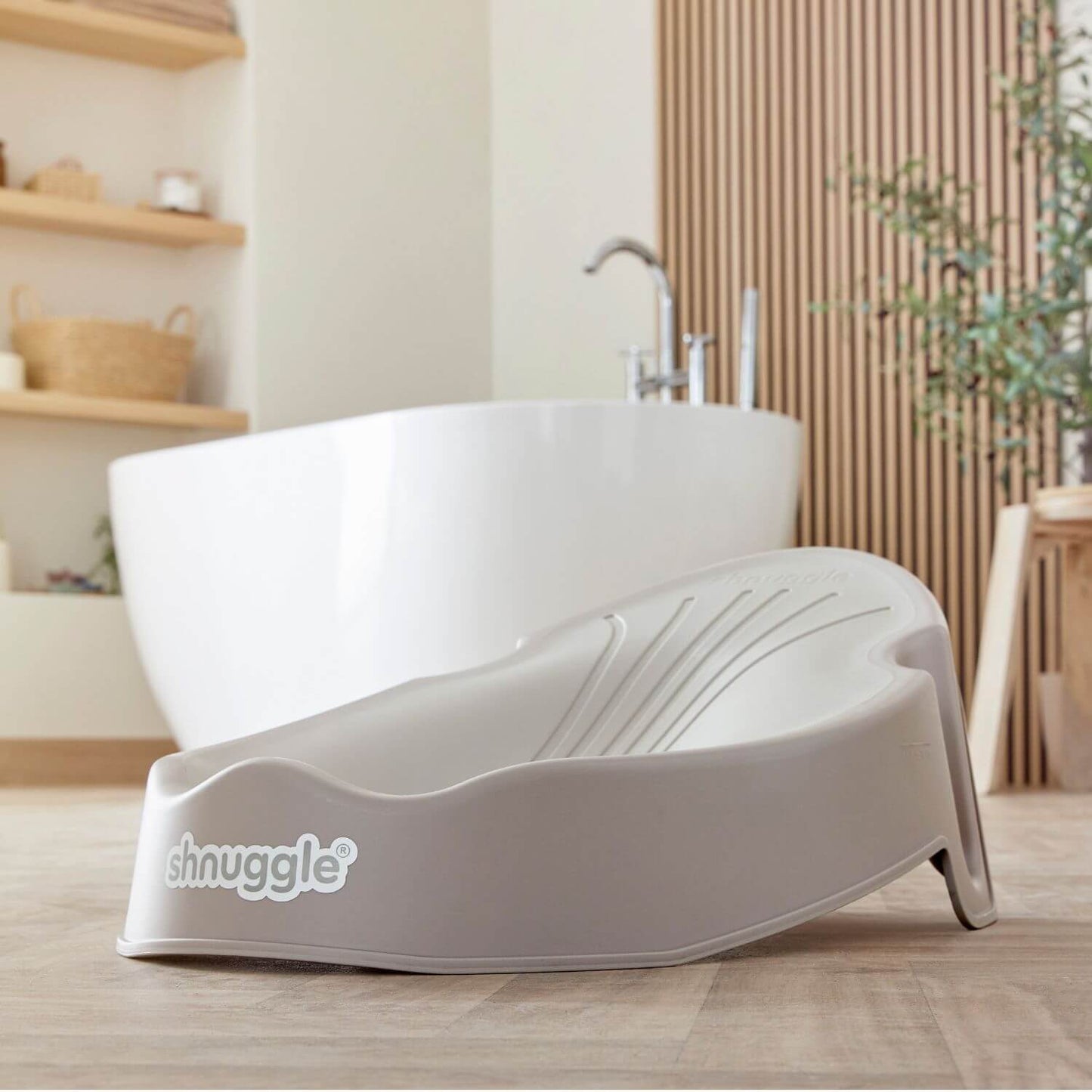 Shnuggle Newborn Baby Bath Support - Taupe in a bathroom