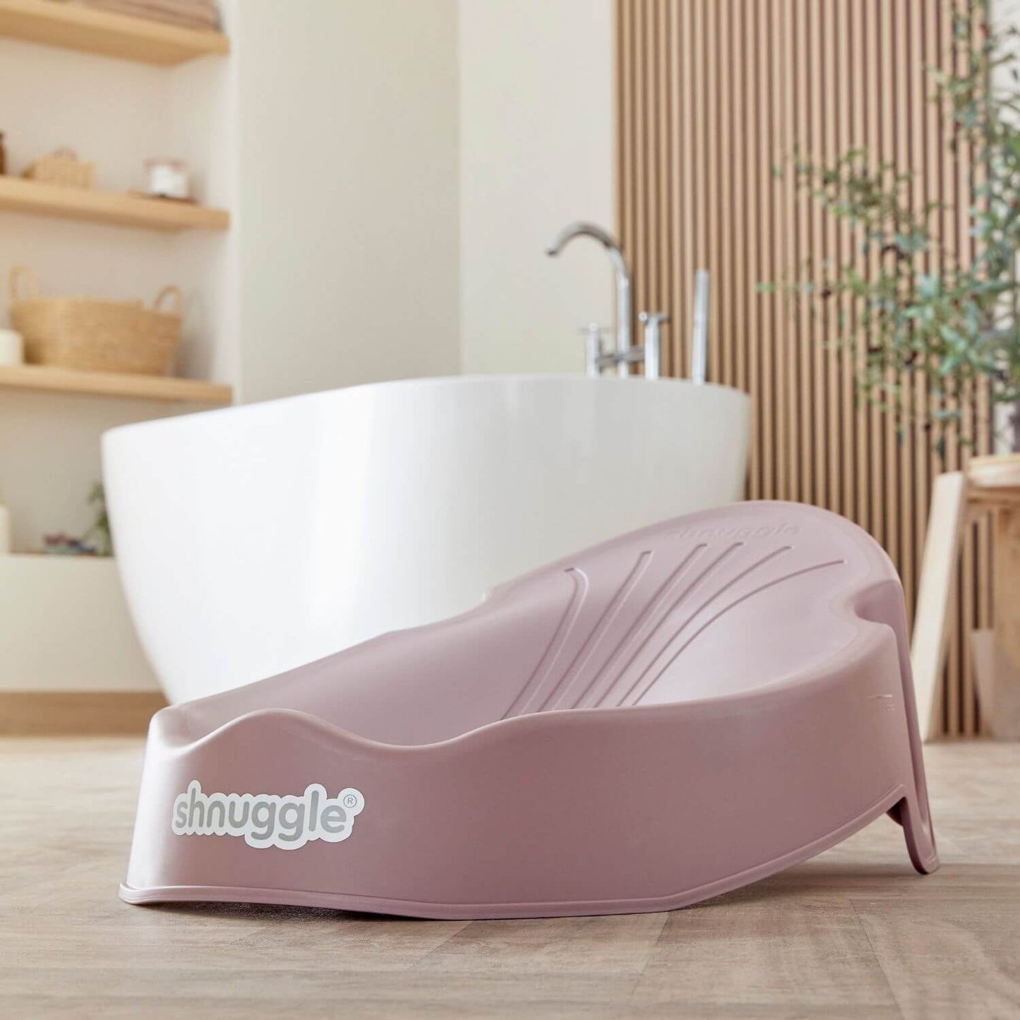 Shnuggle Newborn Baby Bath Support - Blossom in a bathroom