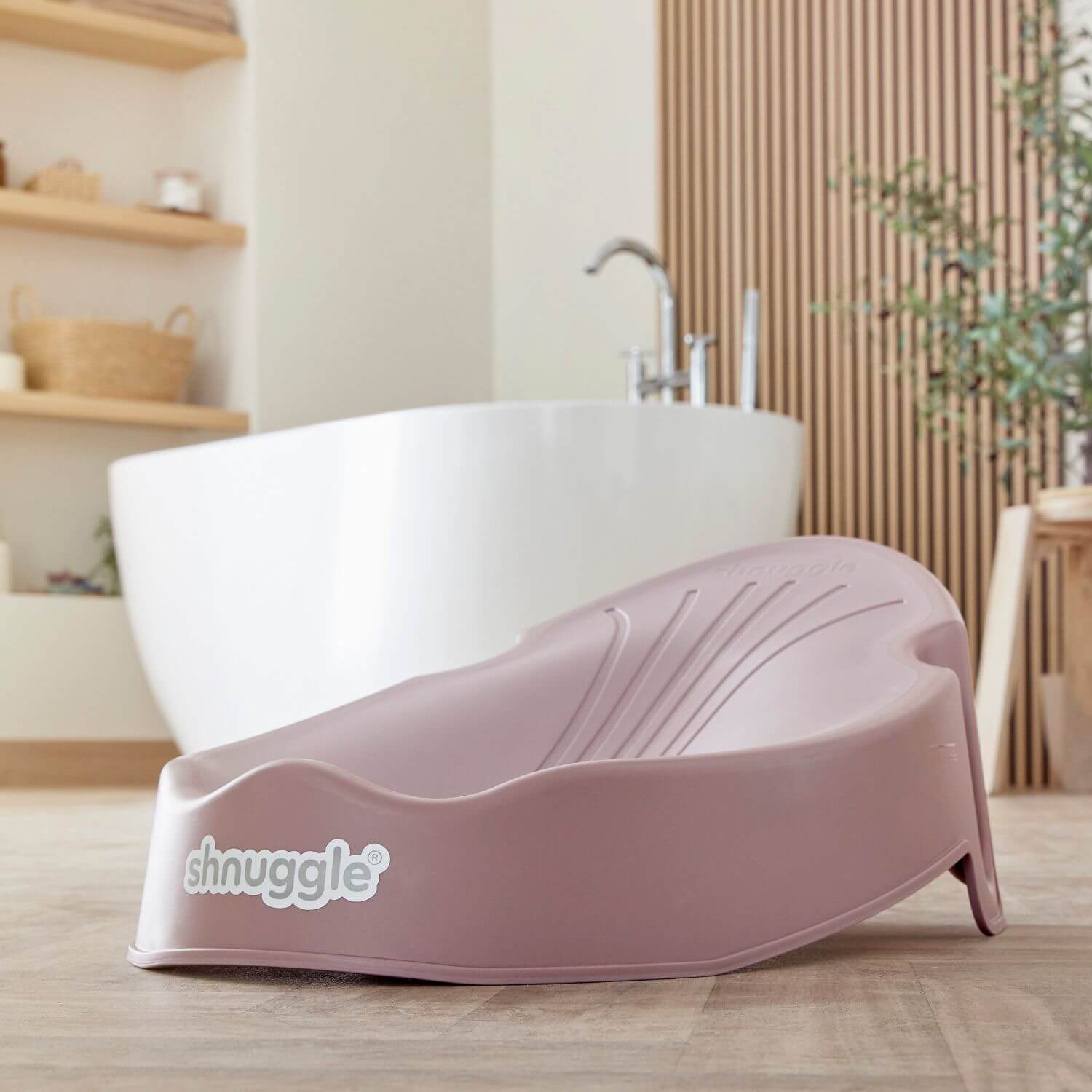 Shnuggle Newborn Baby Bath Support - Blossom in a bathroom