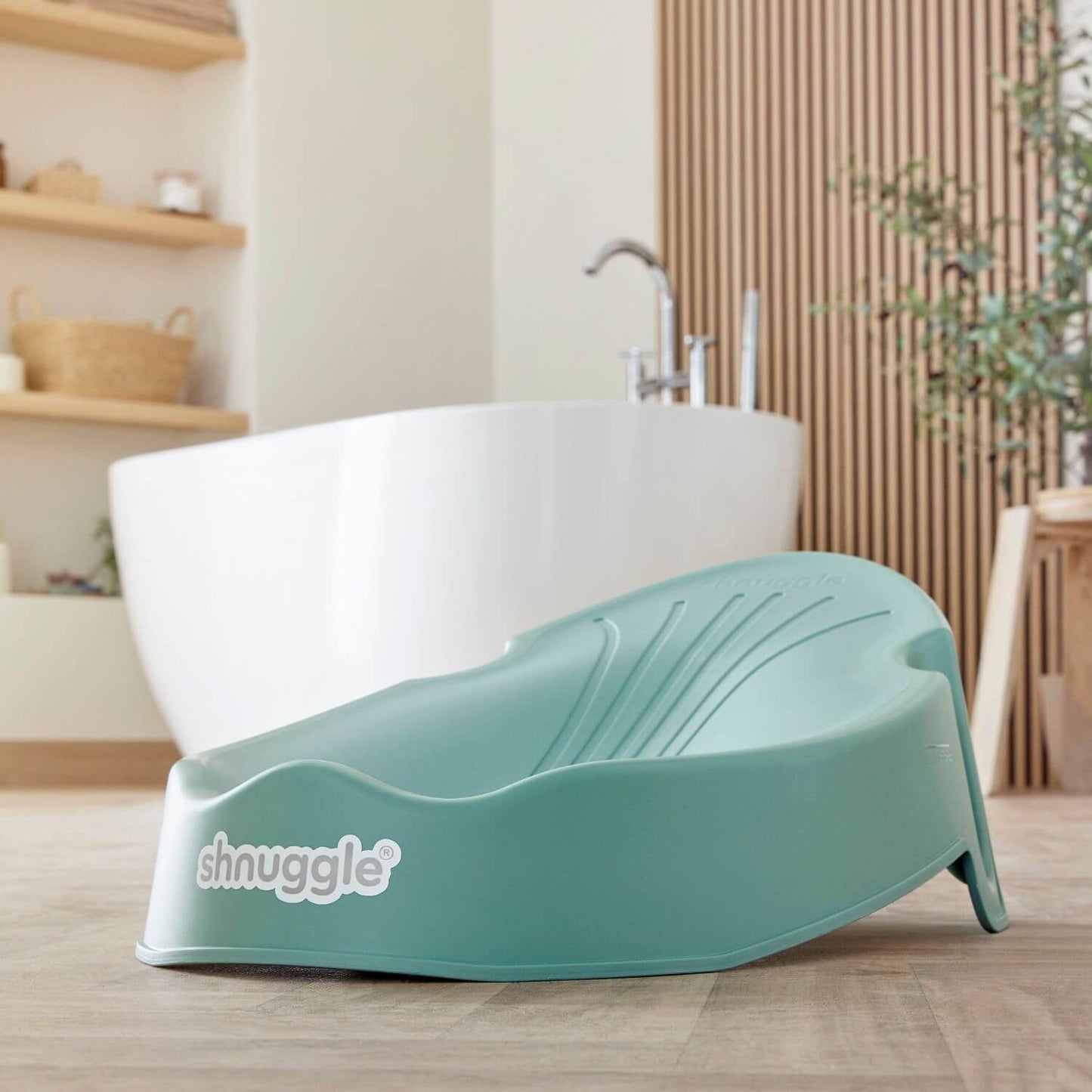 Shnuggle Newborn Baby Bath Support - Eucalyptus in a bathroom