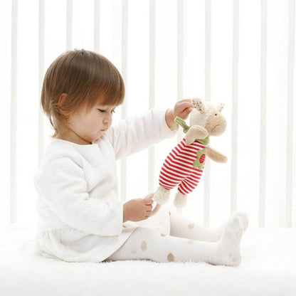 Child playing with sigikid Organic Sheep Musical Toy in a crib