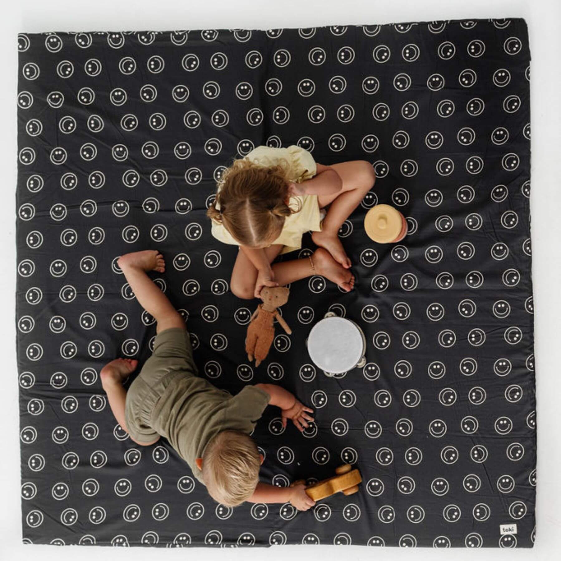 Two children playing on Toki Kids Smiles Organic Cotton Mat