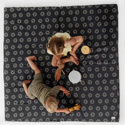 Two children playing on Toki Kids Smiles Organic Cotton Mat