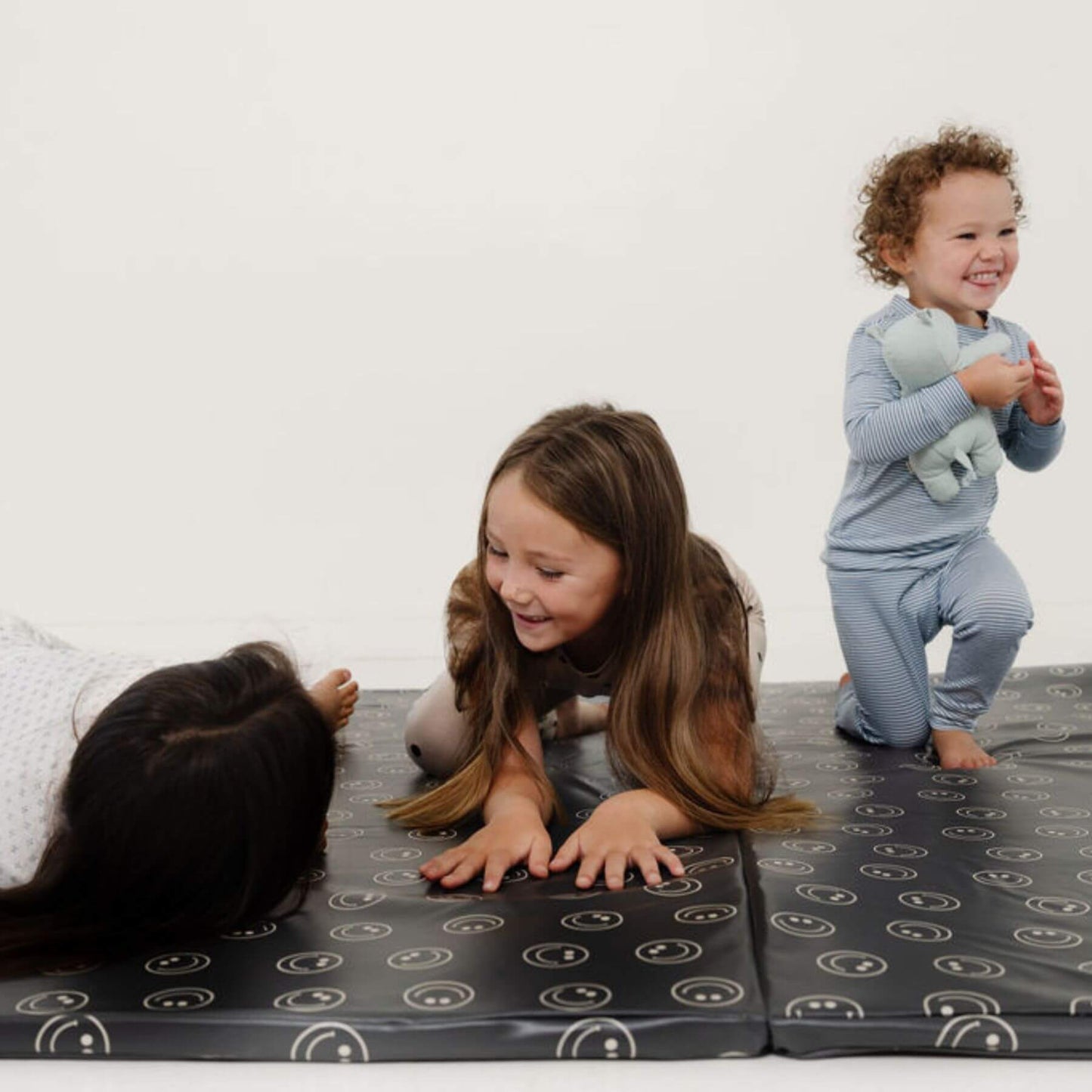 Children playing on Toki Kids Smiles Vegan Leather Mat