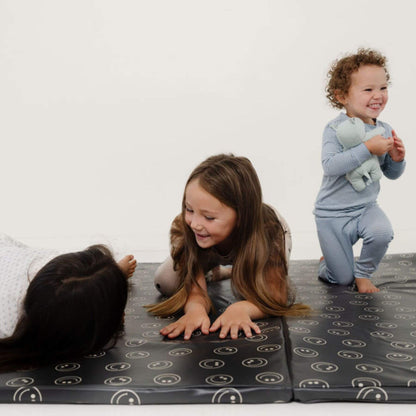 Children playing on Toki Kids Smiles Vegan Leather Mat