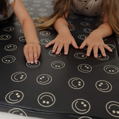 Children's hands on Toki Kids Smiles Vegan Leather Mat