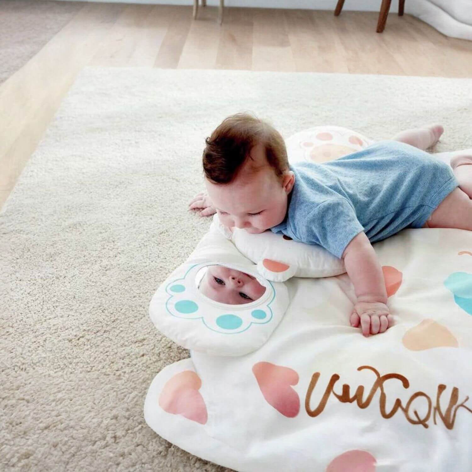 Baby Looking at Himself in the Mirror of Hape Snuggle Bear Activity Gym