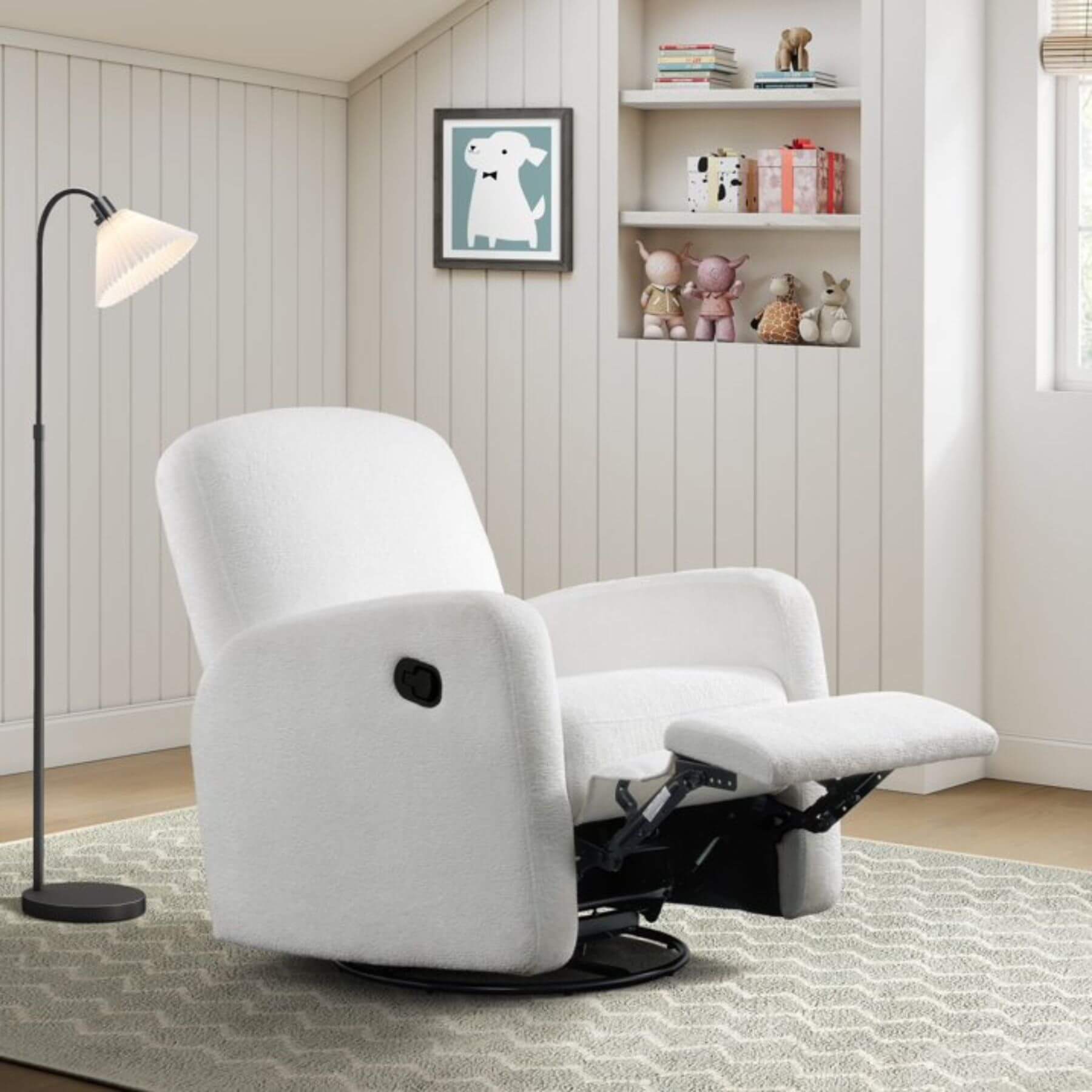 Oxford Baby Snuggly Glider - Plush White in a room with a shelf and lamp.