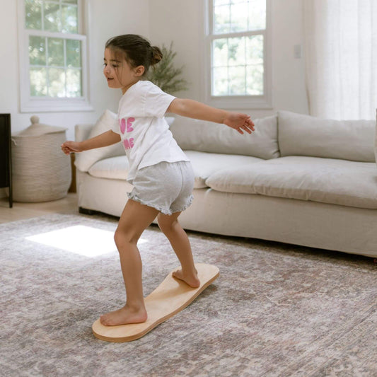 Kid playing with Spinzee Board in a living room