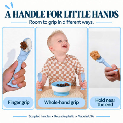 A promotional graphic for Spoon la la Toddler Utensils — 2-Pack - Blue. The image features three panels: a close-up of a hand holding the spoon in a 'Finger grip' position, a baby smiling while holding both utensils in a 'Whole-hand grip' position, and a close-up of the fork with the handle near the end in a 'Hold near the end' position.