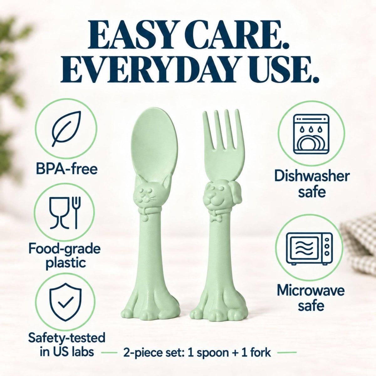 Spoon la la Toddler Utensils — 2-Pack - Green, shaped like cat paws, displayed on a light beige background with promotional text and icons highlighting safety features.