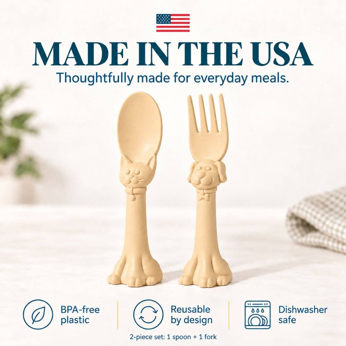 Spoon la la Toddler Utensils — 2-Pack - Yellow, shown on a light tabletop with a soft blurred background. Large text at the top reads 'MADE IN THE USA' with an American flag, and feature icons at the bottom mention BPA-free plastic, reusable by design, and dishwasher safe.