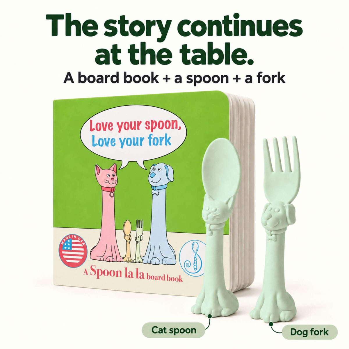 A children's board book set with a spoon and fork. The book cover is bright green with cartoon cat and dog figures and the text 'Love your spoon, Love your fork.