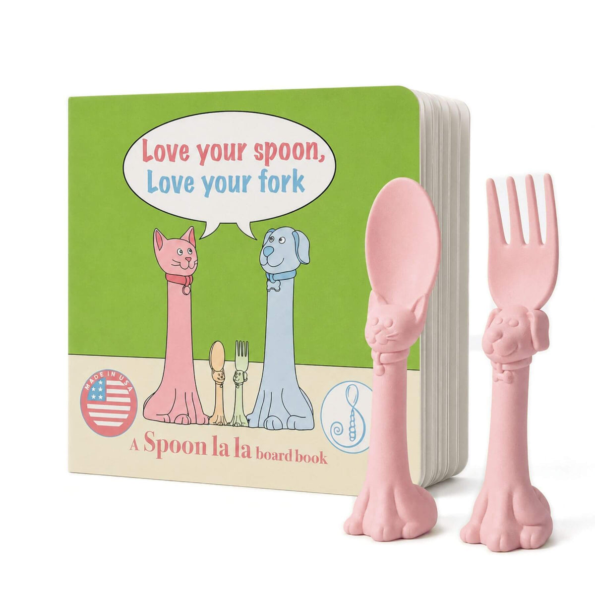 A Spoon la la board book set featuring a green board book with cartoon cat and dog figures and a pink cat-shaped spoon and fork in front on a white background.