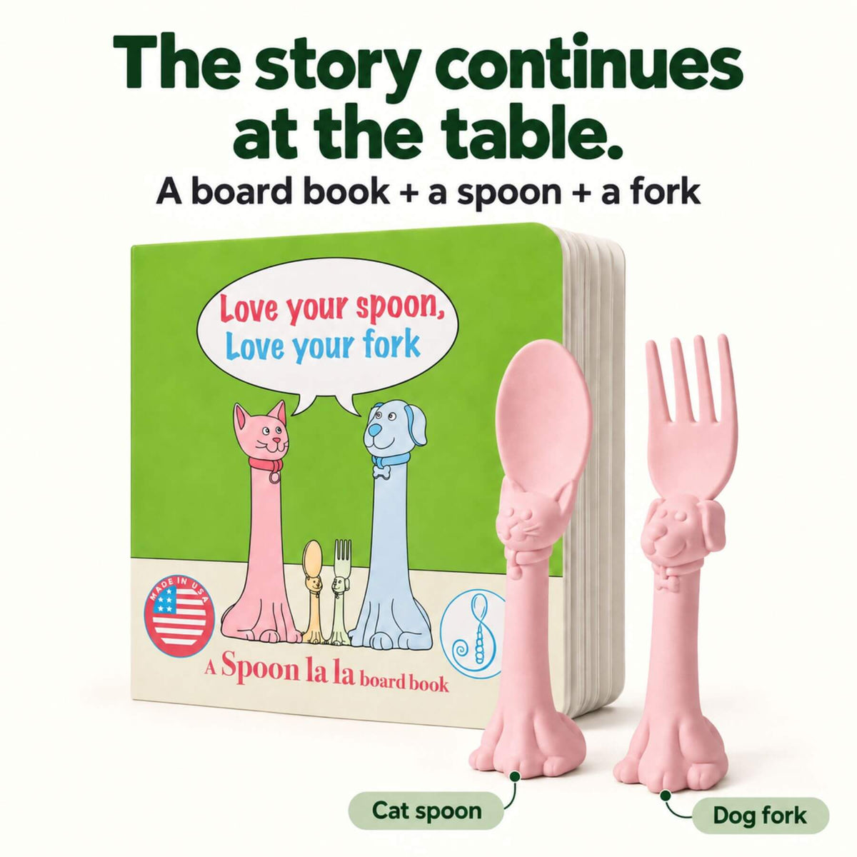 A children's board book and matching utensil set. The set includes a green board book with cartoon cat and dog figures and the text 'Love your spoon, Love your fork,' plus a pink cat-shaped spoon and a pink dog-shaped fork.