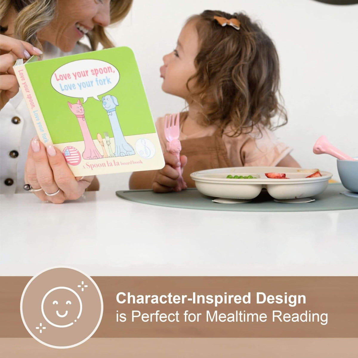 Woman and child at a table with a book titled 'Love your spoon, love your fork' and a pink fork.