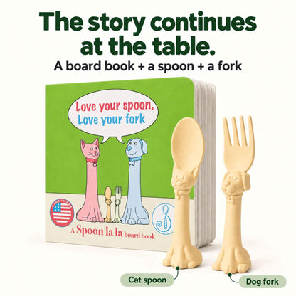 A children's board book 'Love your spoon, Love your fork,' plus a beige cat-shaped spoon and a beige dog-shaped fork.