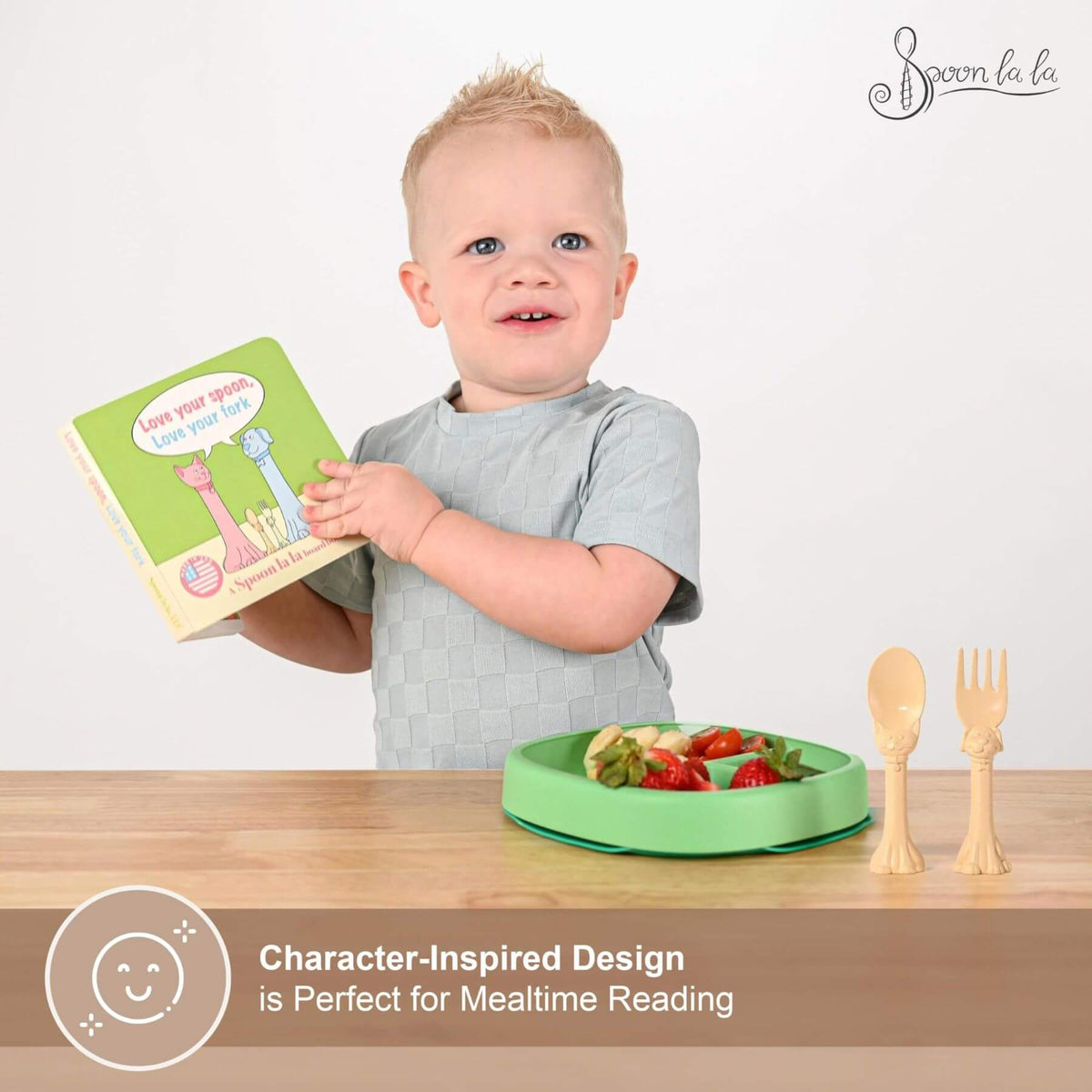 Child holding a book with a plate of food and utensils on a table, featuring Spoonla branding.