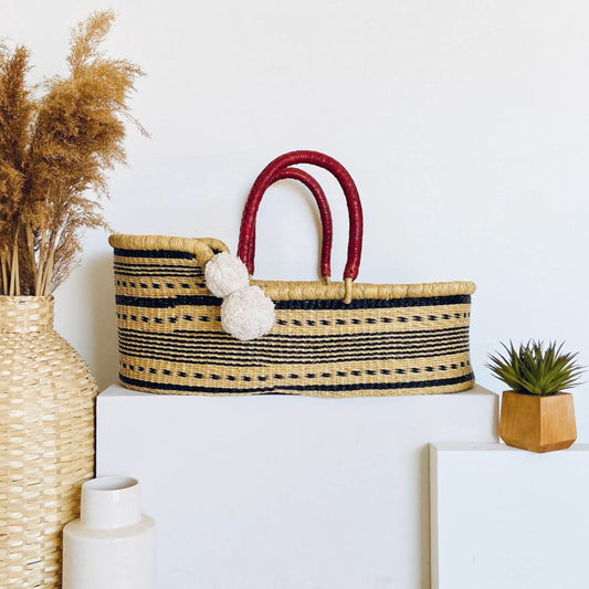 Spring Sparrow African Moses Basket on a white surface, surrounded by decorative items.