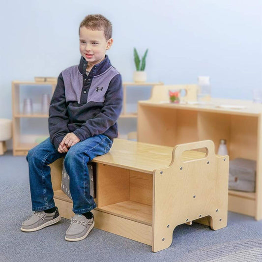 Child sitting on Whitney Brothers Stack-Able™ Bench in a classroom setting