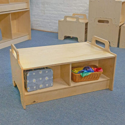 Children's wooden storage bench with shelves and a basket on a blue floor.