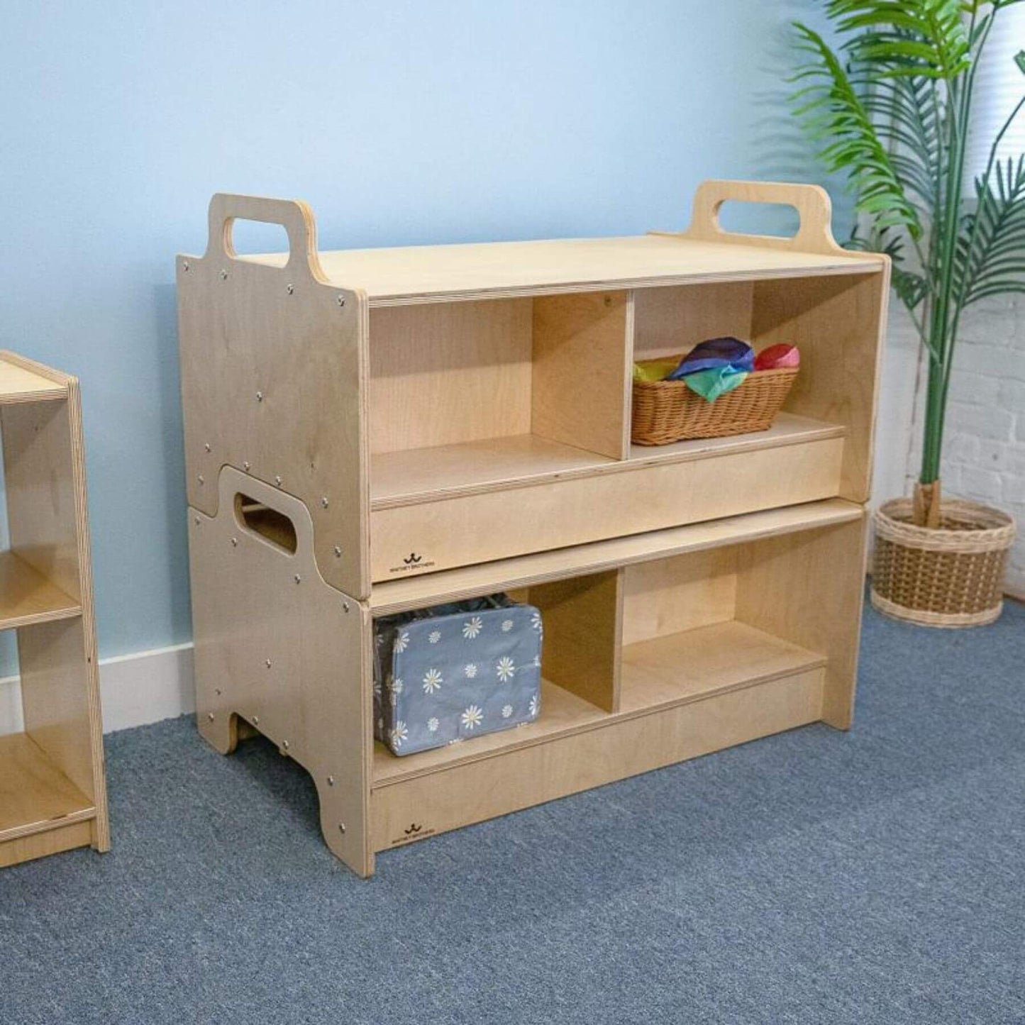 2 Whitney Brothers Stack-Able™ Bench and a basket against a light blue wall.