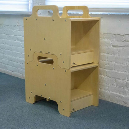2 Whitney Brothers Stack-Able™ Seat against a white brick wall.