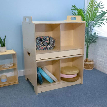 Two Stack-Able™ Table with shelves and colorful items in a room with plants and a blue wall.