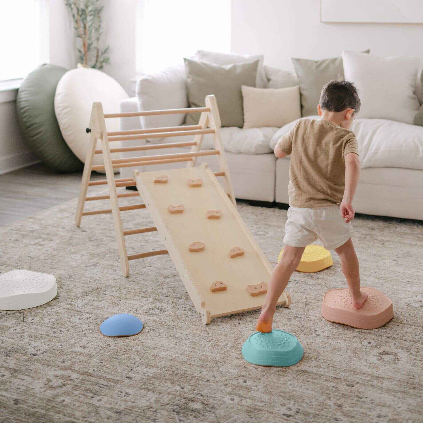 Child playing with Tiny Land® Stepping Stones - Beach Vacation in a living room.