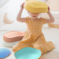 Child playing with Tiny Land® Stepping Stones - Beach Vacation on a light-colored floor.