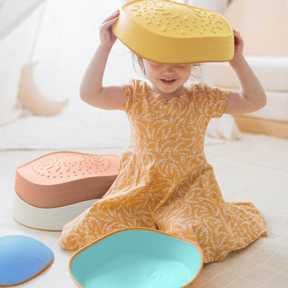 Child playing with Tiny Land® Stepping Stones - Beach Vacation on a light-colored floor.