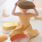 Child playing with Tiny Land® Stepping Stones - Sunset Hues on a light background