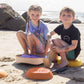Two children sitting on Tiny Land® Stepping Stones - Sunset Hues with a scenic background