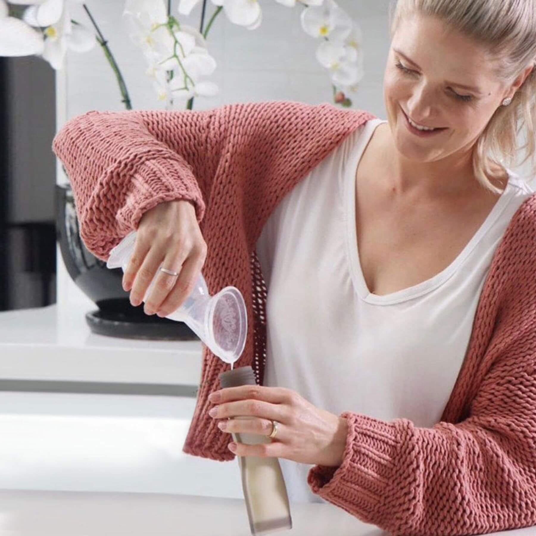 Woman pouring milk into storage bag