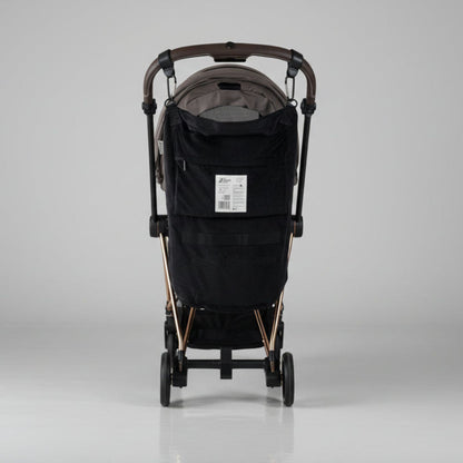 Black stroller with Stroller Sling™ – Black Fox Edition attached on a gray background