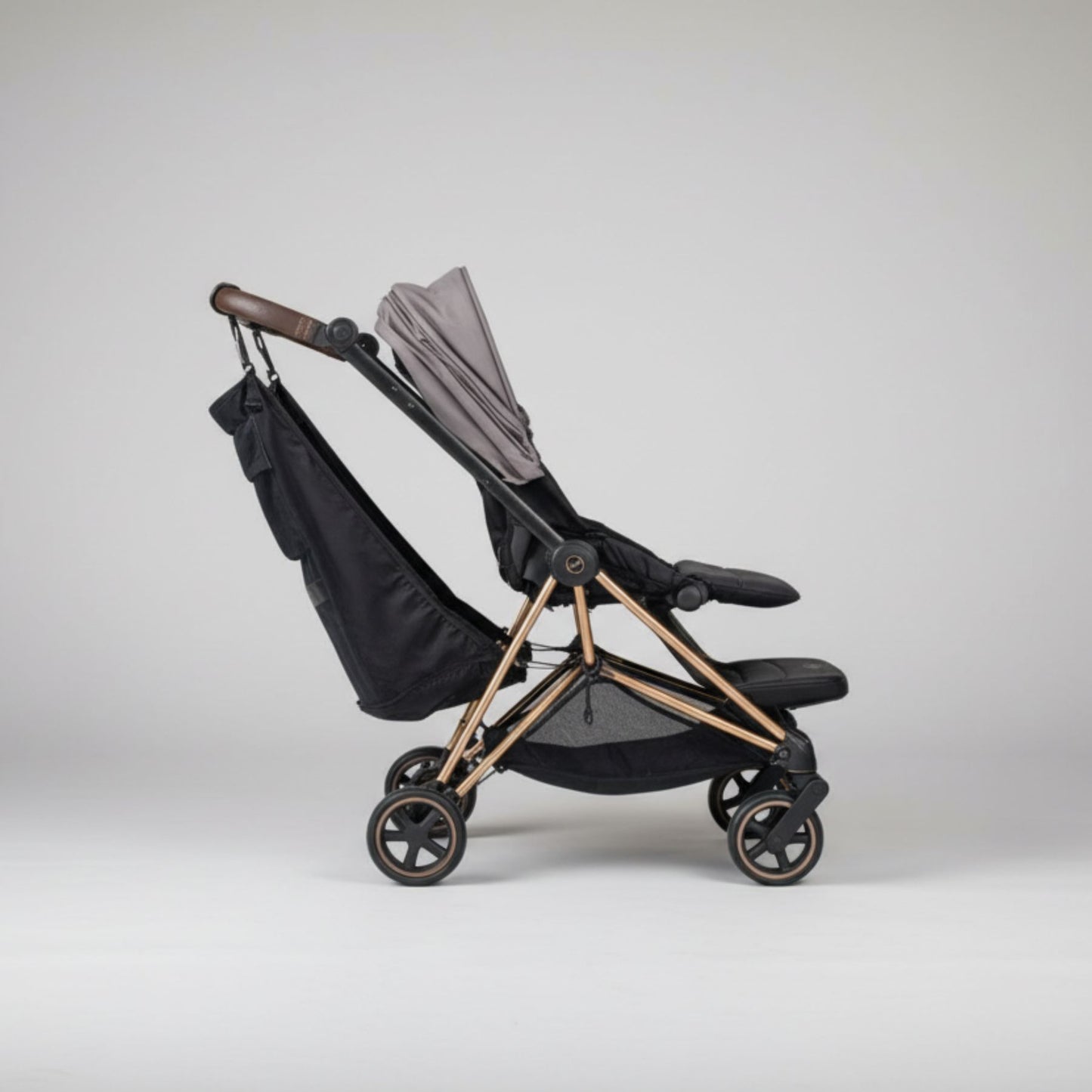 Black and bronze stroller with Stroller Sling™ – Black Fox Edition attachment on a white background