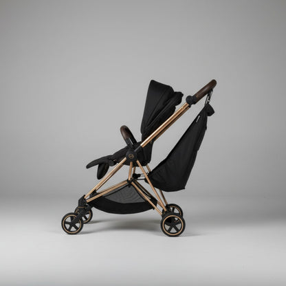 Black stroller with Stroller Sling™ – Black Fox Edition attachment on a gray background