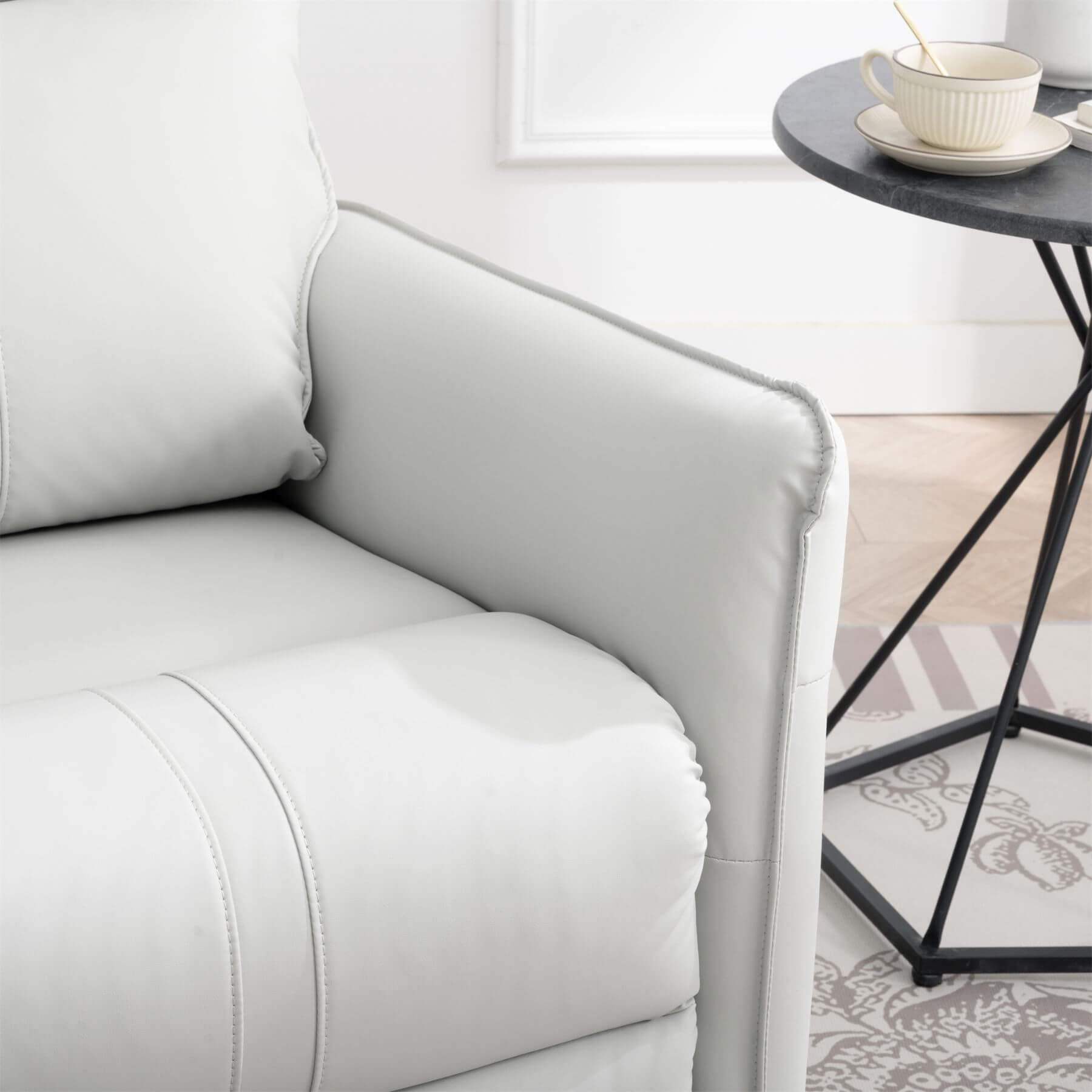 Gray sofa in a living room with a small table and decor items.