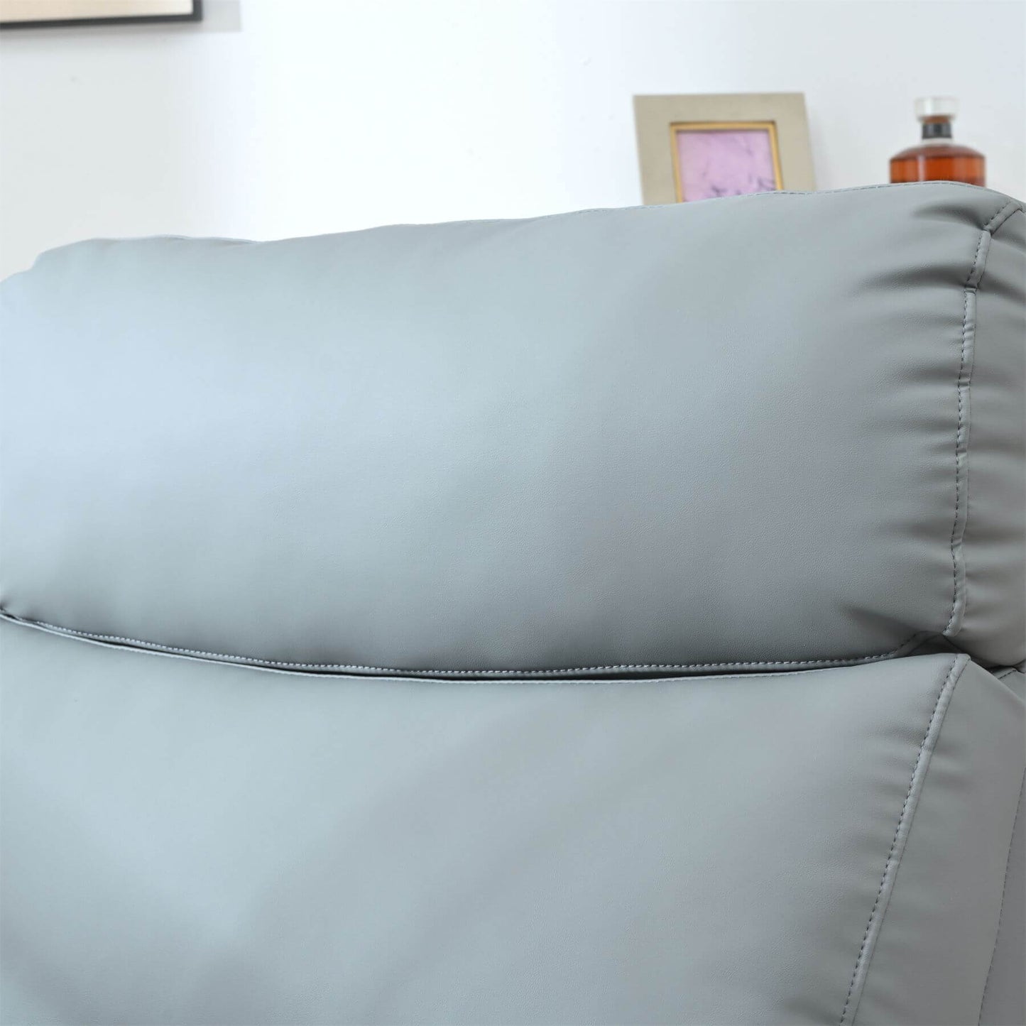 Gray recliner with a close-up of the cushion texture