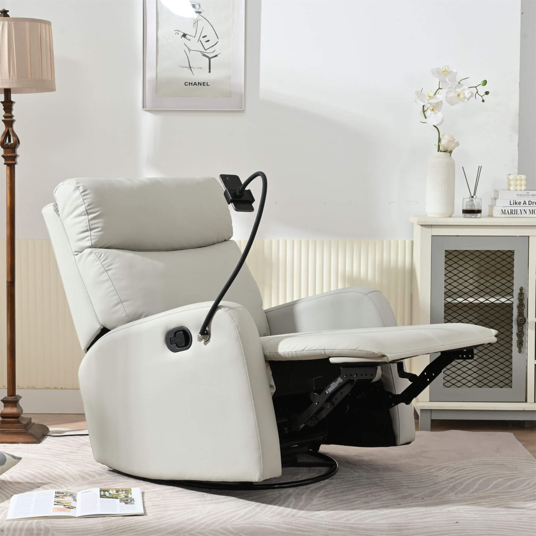 White recliner chair in a living room setting with a lamp and cabinet in the background.