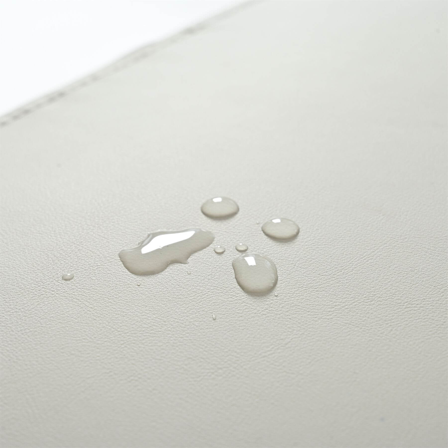 Water droplets on a textured white surface