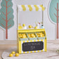 Teamson Sunny Citrus Lemonade Stand Playset with lemons and a chalkboard sign on a light gray floor.