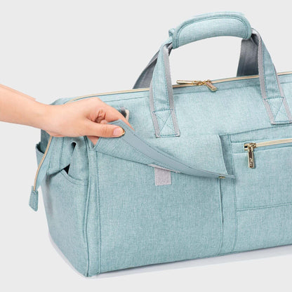 Sunveno 3 in 1 Diaper Travel Tote Bag - Green with a hand holding it on a light gray background