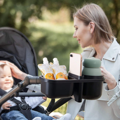 Woman with a baby in a stroller using Sunveno 3-in-1 Stroller Cup Holder with drinks and a phone.