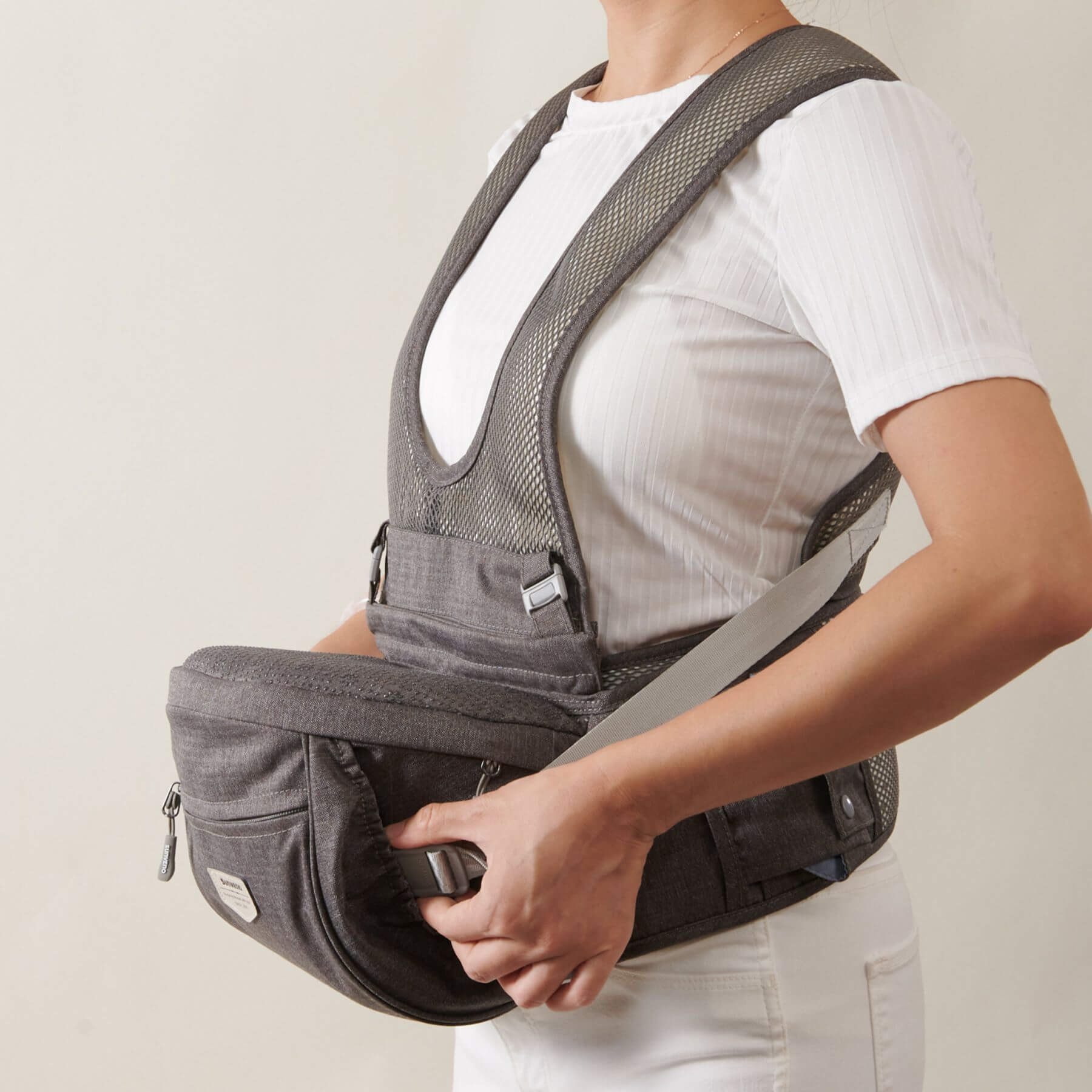 Person wearing Sunveno Two Shoulder Straps Baby Hipseat with a plain background