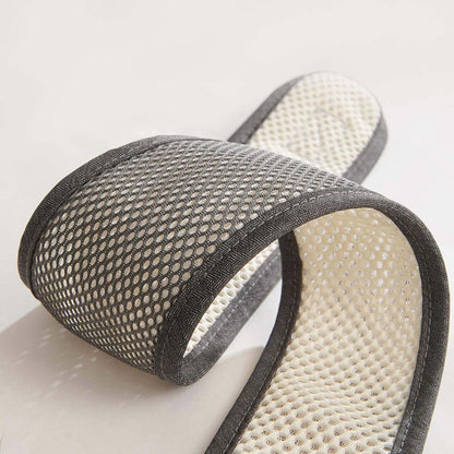 Pair of gray mesh slippers on a light background