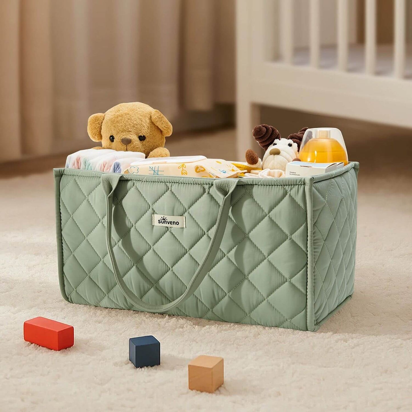 Sunveno Quilted Diaper Caddy Organizer - Green with toys on a carpeted floor
