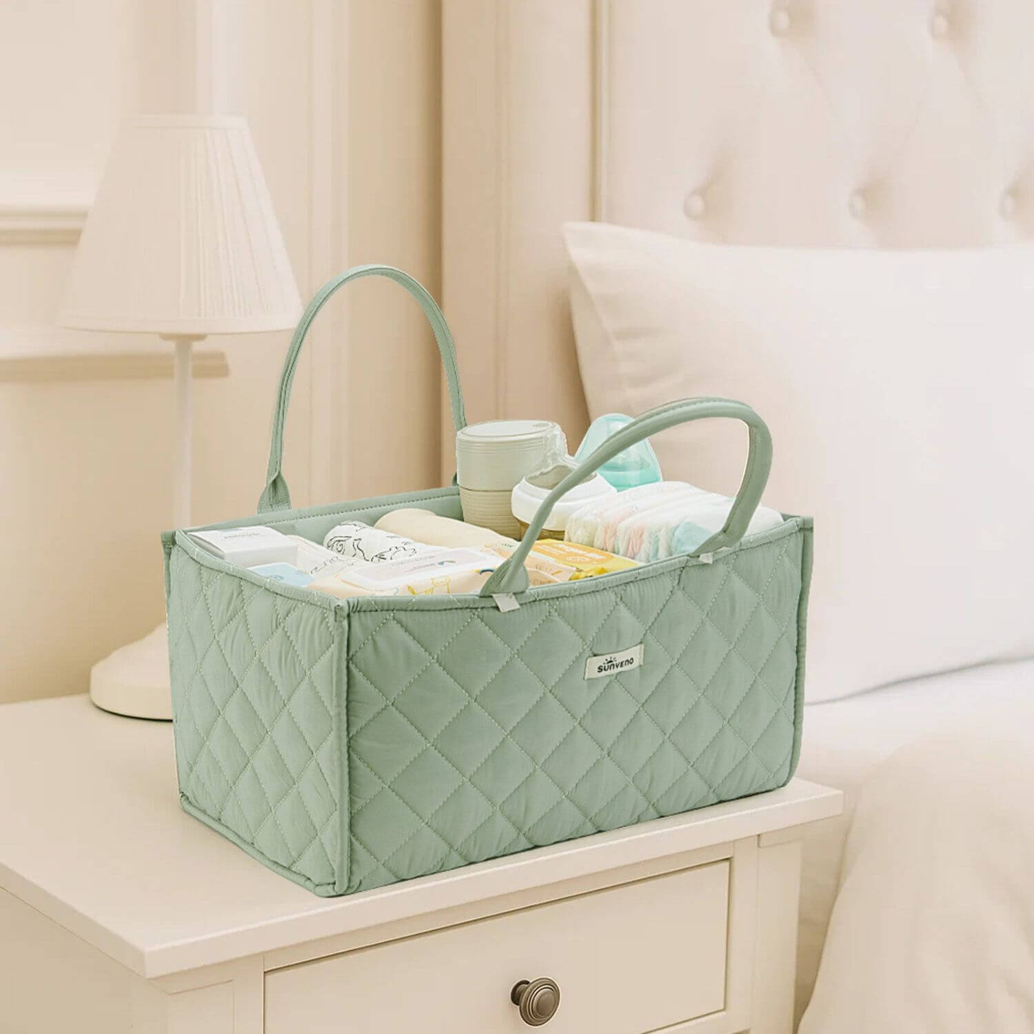 Sunveno Quilted Diaper Caddy Organizer - Green on a nightstand with baby items inside.