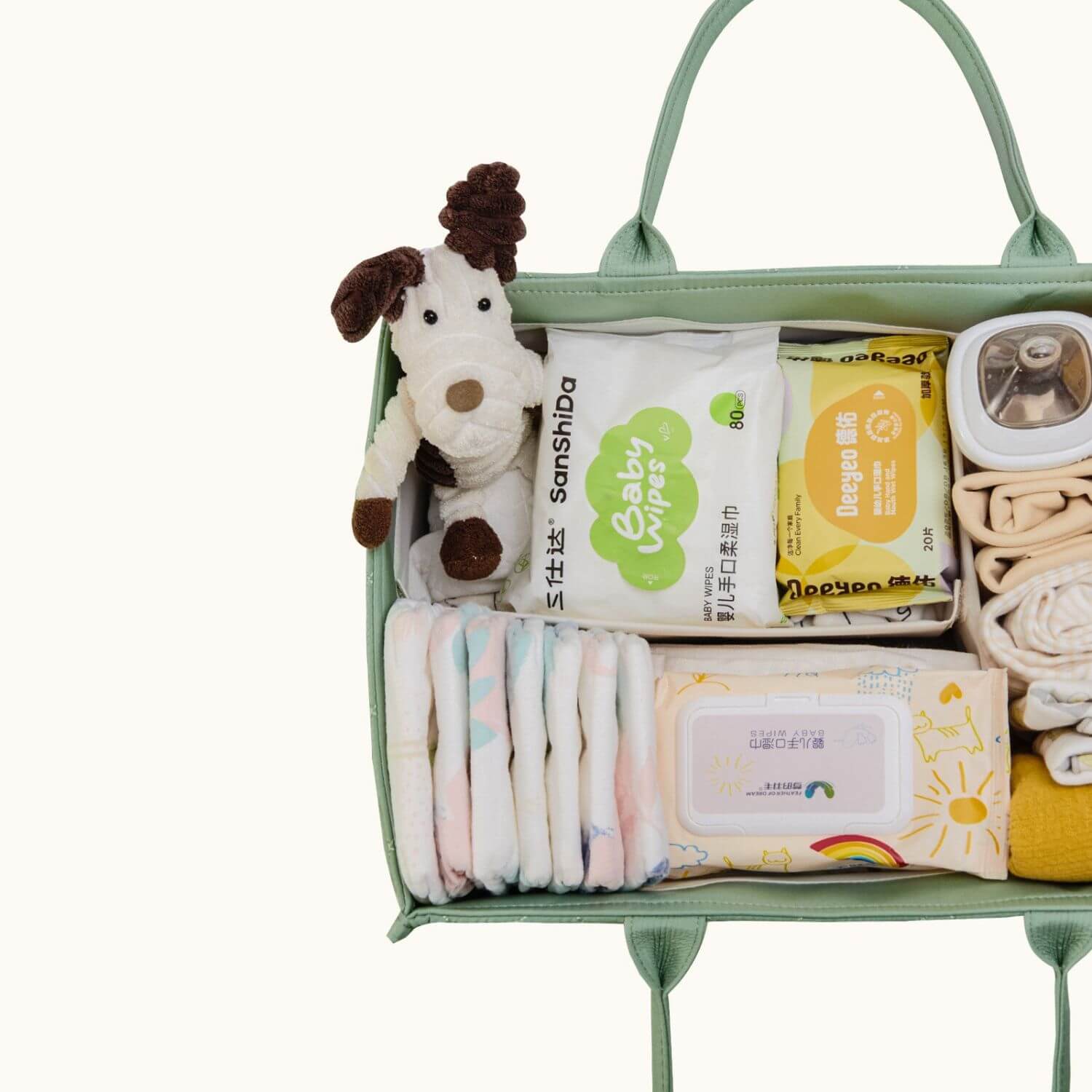 Sunveno Quilted Diaper Caddy Organizer - Green with diapers, wipes, and a plush toy on a white background